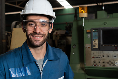 Young skillful factory worker or engineer close up portrait in factory . Industry and engineering...