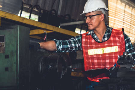 Smart factory worker or engineer do machine job in a manufacturing workshop . Industry and engineering concept .の写真素材