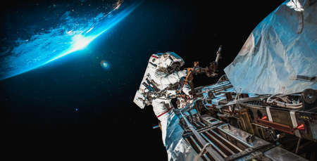 Astronaut spaceman do spacewalk while working for space station in outer space . Astronaut wear full spacesuit for space operation .の写真素材