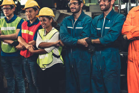Skillful worker stand together showing teamwork in the factory . Industrial people and manufacturing labor concept .の写真素材