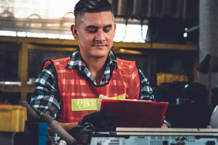 Manufacturing worker working with clipboard to do job procedure checklist . Factory production line...