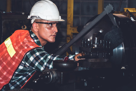 Smart factory worker or engineer do machine job in a manufacturing workshop . Industry and...