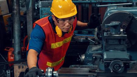 Skillful factory worker or engineer do machine job in manufacturing workshop . Industrial people and...