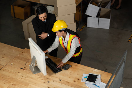 Warehouse manager and worker working in the storehouse . Logistics , supply chain and warehouse...