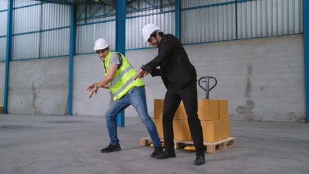Funny factory workers dance in the factory . Happy people at work .の写真素材