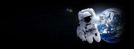 Astronaut spaceman do spacewalk while working for space station in outer space . Astronaut wear full spacesuit for space operation .の写真素材