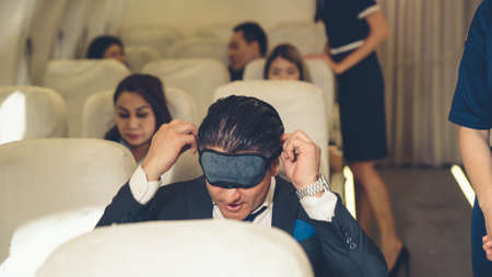 Sleepy businessman travel on a business trip by airplane . Executive traveler concept .の写真素材