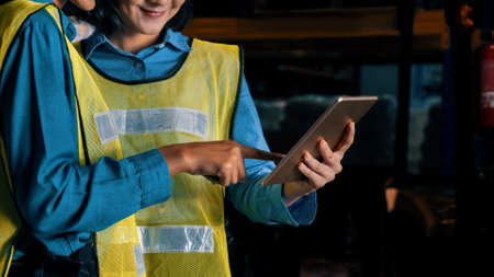 Female warehouse worker working at the storehouse . Logistics , supply chain and warehouse business concept .の写真素材
