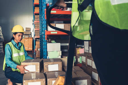 Female warehouse worker working at the storehouse . Logistics , supply chain and warehouse business concept .の写真素材
