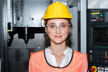Young woman factory worker close up portrait in manufacturing job factory . Industry and engineering concept .の写真素材
