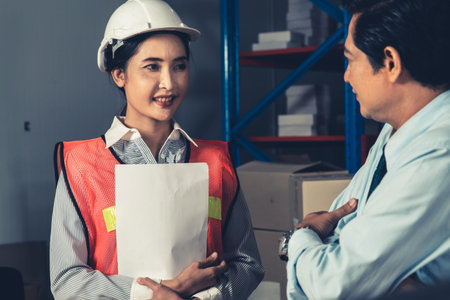 Warehouse manager and worker working in the storehouse . Logistics , supply chain and warehouse...