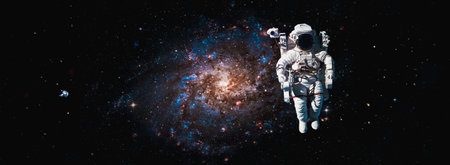 Astronaut spaceman do spacewalk while working for space station in outer space . Astronaut wear full spacesuit for space operation .の写真素材