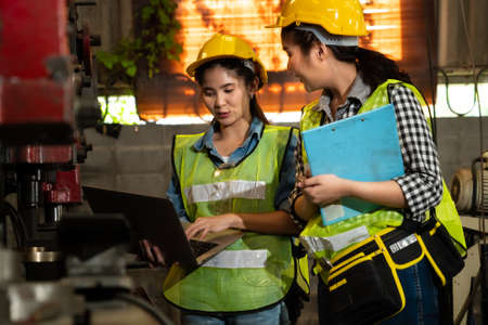 Factory job workers working and discussing manufacturing plan in the factory . Industry and engineering concept .の写真素材