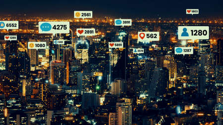 Social media icons fly over city downtown showing people engagement connection through social network application platform . Concept for online community and social media marketing strategy .の写真素材
