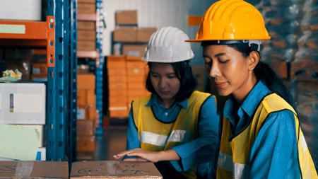 Female warehouse worker working at the storehouse . Logistics , supply chain and warehouse business concept .の写真素材