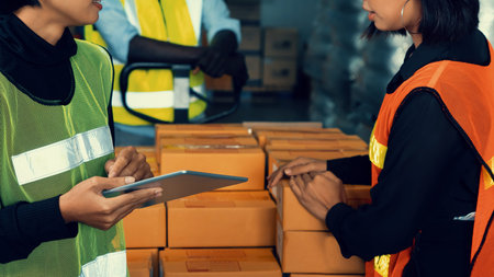 Warehouse worker working together in the storehouse . Logistics , supply chain and warehouse business concept .の写真素材