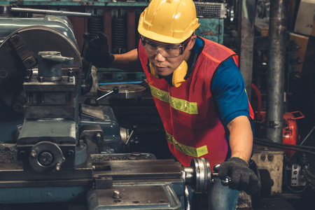 Skillful factory worker or engineer do machine job in manufacturing workshop . Industrial people and...