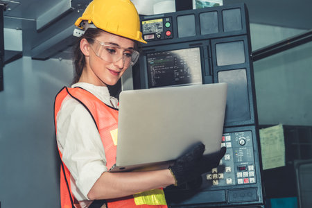 Smart factory worker or engineer do machine job in the manufacturing workshop . Industry and...