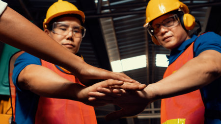 Team of skillful factory workers showing unity partnership and support . Industrial people and manufacturing labor concept .の写真素材