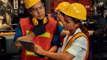Group of skillful workers using machine equipment in factory workshop . Industry and engineering...