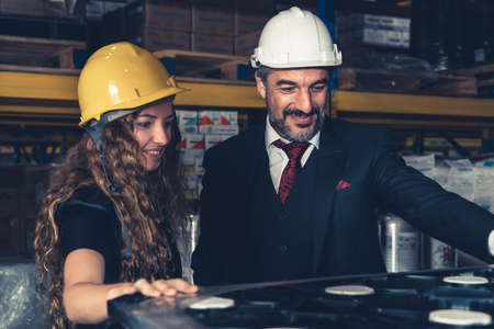 Warehouse senior manager talking to worker in the storehouse . Logistics , supply chain and warehouse business concept .の写真素材