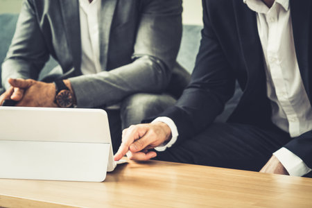 Businessman is in meeting discussion with another businessman partner in modern workplace office. People corporate business team concept.の写真素材