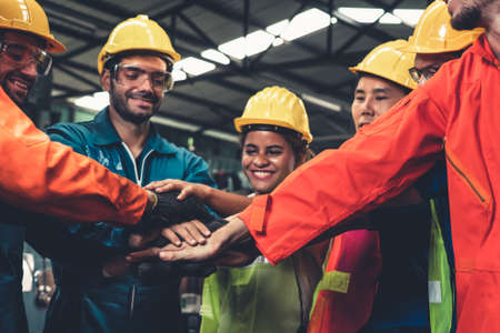 Skillful worker stand together showing teamwork in the factoryの写真素材
