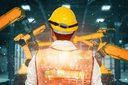 Mechanized industry robot arm and factory worker double exposureの写真素材