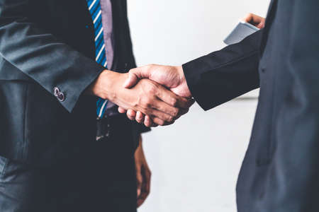 Business people agreement concept. Businessman do handshake with another businessman in the office meeting room.の写真素材