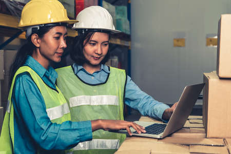 Female warehouse worker working at the storehouse . Logistics , supply chain and warehouse business concept .の写真素材