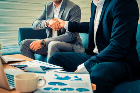 Businessman handshake with another businessman partner in modern workplace office. People corporate business deals concept.の写真素材