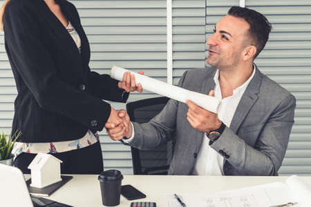 Businessman executive handshake with businesswoman worker in modern workplace office. People corporate business deals concept.の写真素材