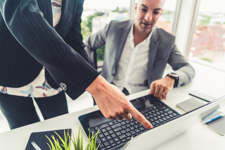 Businessman executive is in meeting discussion with a businesswoman worker in modern workplace...