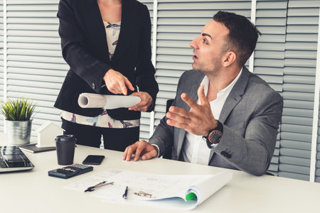 Businessman executive checking work while meeting discussion with businesswoman worker in modern workplace office. People corporate business team concept.の写真素材
