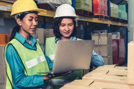 Female warehouse worker working at the storehouse . Logistics , supply chain and warehouse business concept .の写真素材
