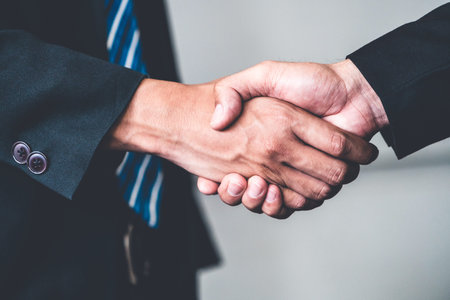 Business people agreement concept. Businessman do handshake with another businessman in the office...