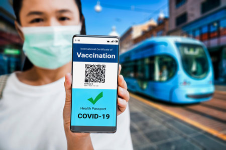 Traveler holds vaccine passport certificate to show COVID 19 vaccination status . The digital health...
