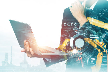 Mechanized industry robot arm and factory worker double exposure . Concept of robotics technology for industrial revolution and automated manufacturing process .の写真素材