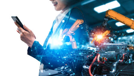 Mechanized industry robot arm and factory worker double exposure . Concept of robotics technology for industrial revolution and automated manufacturing process .の写真素材