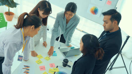 Business people proficiently discuss work project on meeting table . Corporate business team collaboration concept .の写真素材