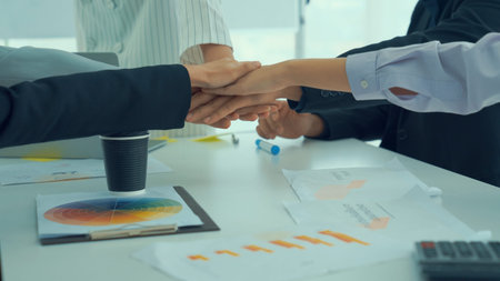 Business people proficiently celebrate project success at office workplace . Corporate business team...
