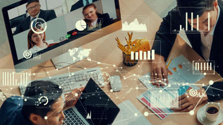 Creative visual of business people in a corporate staff meeting on video call . Concept of digital technology for marketing data analysis and investment decision making .の写真素材