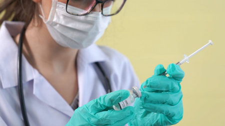 Skillful doctor prepare vaccine proficiently before injection .