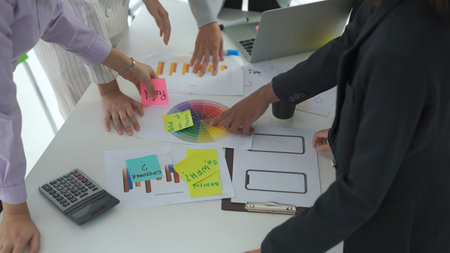 Business people proficiently discuss work project on meeting table . Corporate business team...