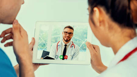 Doctor telemedicine service online video for virtual patient health medical chat . Remote doctor healthcare consultant from home using online mobile device connect to internet for live video call .の写真素材