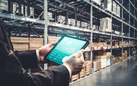 Warehouse management innovative software in computer for real time monitoring of goods package delivery . Computer screen showing smart inventory dashboard for storage and supply chain distribution .の写真素材
