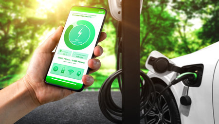 EV charging station for electric car with mobile app display charger status . The electric power is...