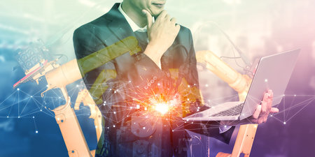 Mechanized industry robot arm and factory worker double exposure . Concept of robotics technology for industrial revolution and automated manufacturing process .の写真素材