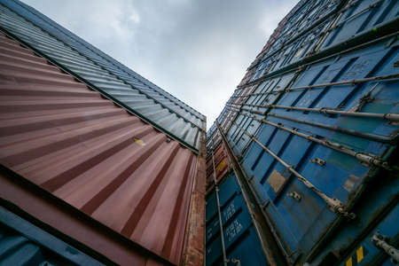 Cargo container for overseas shipping on high stack look up from ground . Logistics supply chain management and international goods export concept .の写真素材