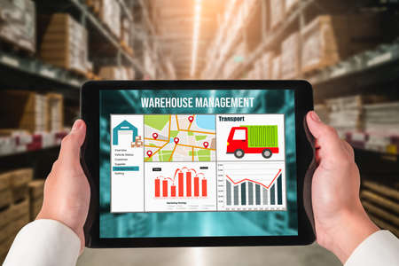 Warehouse management innovative software in computer for real time monitoring of goods package delivery . Computer screen showing smart inventory dashboard for storage and supply chain distribution .の写真素材